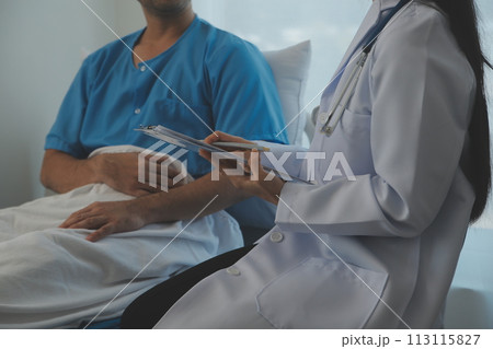 Young doctor is using a stethoscope listen to the heartbeat of the patient. Shot of a female doctor giving a male patient a check up 113115827