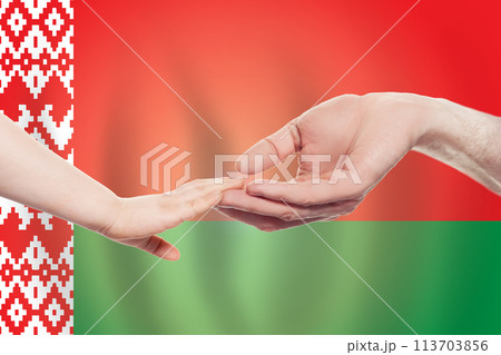 Belarussian baby and parent hands on the background of flag of Belarus.  113703856