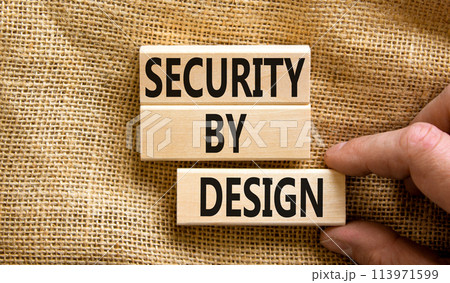 Security by design symbol. Concept words Security by design on wooden blocks on a beautiful canvas table canvas background. Businessman hand. Business finacial security by design concept. Copy space. 113971599