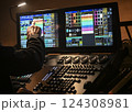 Lighting technician controls stage setup during evening concert in a vibrant venue with dynamic 124308981
