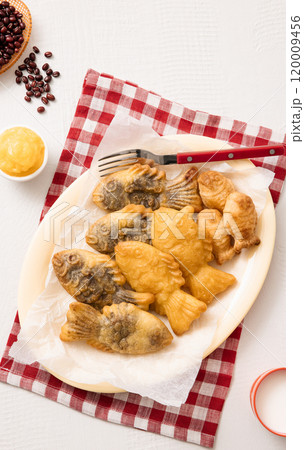 Red bean bungeoppang puff pastry and cream bungeoppang beautifully plated on a red checkered tablecloth 120009456