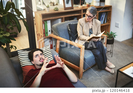 The first step in getting better is getting help. Shot of a young man having a therapeutic session with a psychologist. 120146418