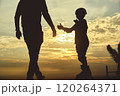 Silhouette of father and son training in saktepark rollerblading, summer sunset background. Culture Enjoy Sports Vacation 120264371