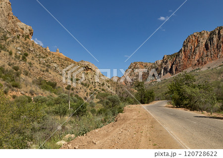 Majestic Noravank monastery nestled among the vibrant red mountains of Armenia in a clear and sunny day 120728622