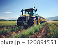 A farmer fertilizes plants with the help of a tractor and a sprayer. 120894551