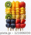 Fresh fruit skewers featuring vibrant kiwi, mango, pineapple, strawberries, and blueberries arranged beautifully. Perfect for healthy snacks or summer parties 121006030