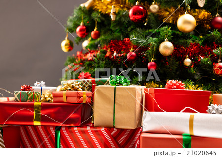 Presents and christmas tree with baubles, decorations and copy space 121020645