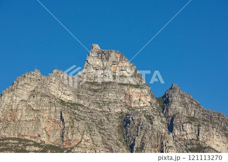 Landscape view of Table Mountain in Cape Town, South Africa with blue sky and copy space. Low angle of a steep, rough and rugged famous hiking terrain. Risky and dangerous challenge to climb the peak 121113270