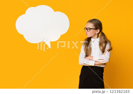 Discontented Schoolgirl Thinking Negative Thoughts Standing Near Speech Bubble Over Yellow Background. Mockup, Studio Shot 121382183