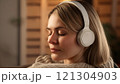 Portrait of beautiful woman with headphones enjoying music, generative ai 121304903