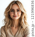 Young woman with blonde hair and glasses smiling confidently indoors during daylight 121996836