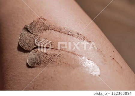 Coffee cream scrub on human skin close-up. 122363854