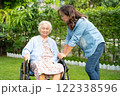 Caregiver help and care Asian senior woman patient sitting on wheelchair at nursing hospital ward, healthy strong medical. 122338596