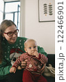 A heartwarming and festive moment shared between a mother and her child in a holiday sweater 122466901