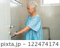 Asian elderly woman patient use toilet bathroom handle security in nursing hospital, healthy strong medical concept. 122474174