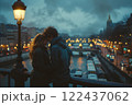 A couple is kissing on a bridge over a river 122437062