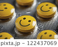 A group of yellow pills with smiling faces on them. happy concept 122437069