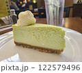 Key Lime Cheesecake Close-Up in Cozy Restaurant Setting 122579496