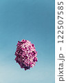 Creative Levitating flying Easter egg shape made of lilac spring petals flowers. Minimal holiday concept still life. Copy space greeting card 122507585