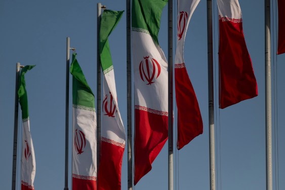 Iranian flags wave in the wind during a military parade.