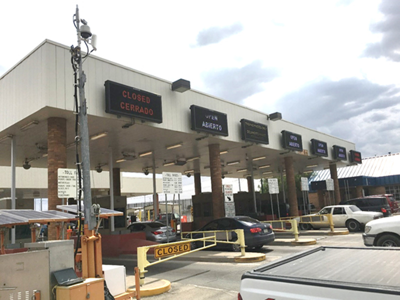 Vehicles going through a toll booth in El Paso.