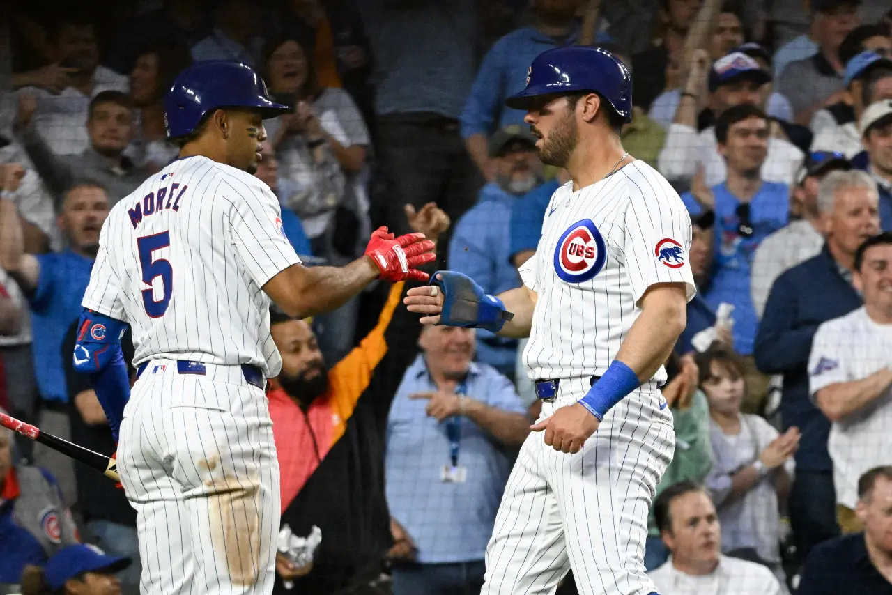 Chicago Cubs outfielder Mike Tauchman (40) high fives third baseman Christopher Morel (5) after scoring against the Pittsburgh Pirates during the fifth inning at Wrigley Field.