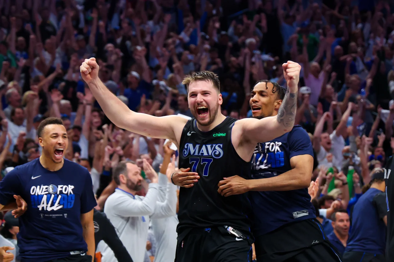 Dallas Mavericks guard Luka Doncic (77) celebrates with teammates after the game against the Oklahoma City Thunder in game six of the second round of the 2024 NBA playoffs at American Airlines Center.