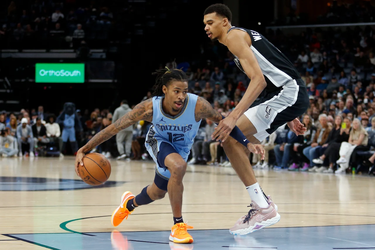 Memphis Grizzlies guard Ja Morant (12) drives to the basket as San Antonio Spurs center Victor Wembanyama (1) defends during the first half at FedExForum.