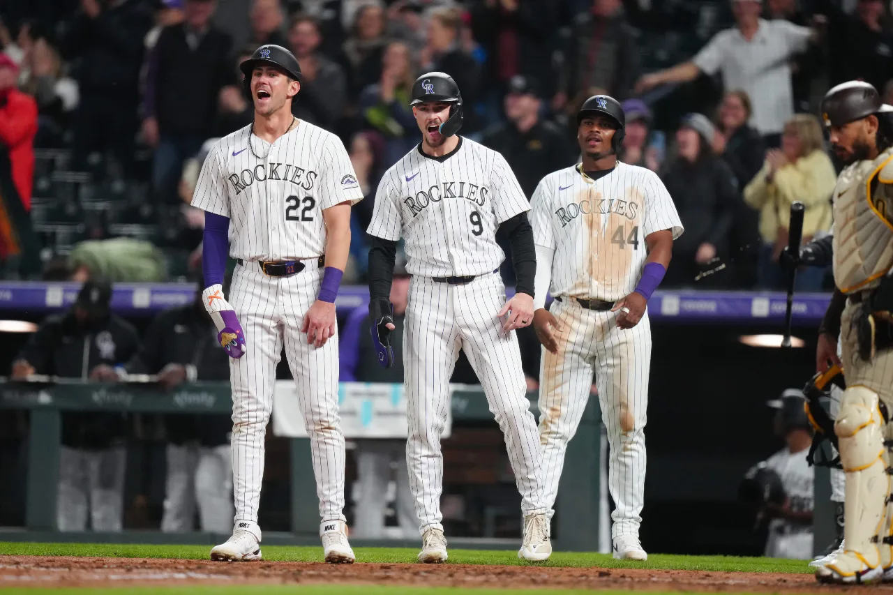 Colorado Rockies outfielder Nolan Jones (22) and outfielder Brenton Doyle (9) and first base Elehuris Montero (44) await to congradulate second base Brendan Rodgers (7) (not pictured) for a grand slam in the fourth inning against the San Diego Padres at Coors Field.