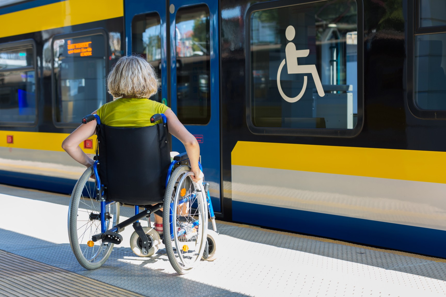 photo of a wheelchair user boarding a bus