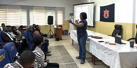 Dr. Quansah speaking to a group of people.