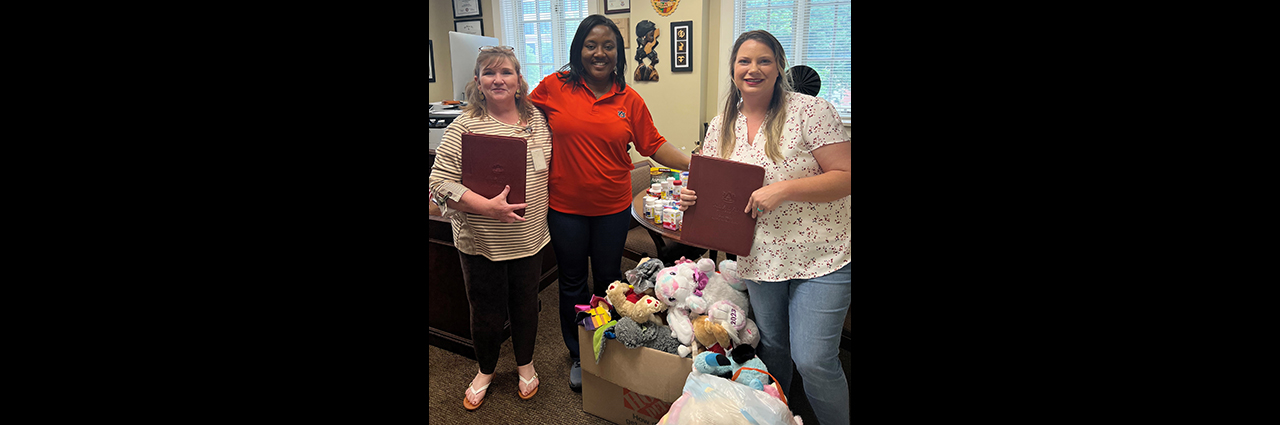 Dr. Quansah receiving stuffed animals donation