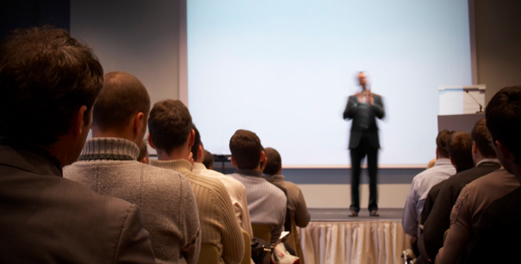 Presenter gives talk to audience about tax topics.