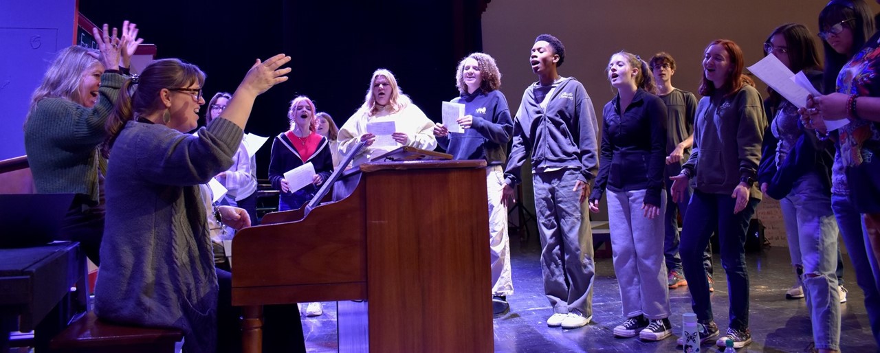 Students rehearse a musical on stage at KCHS