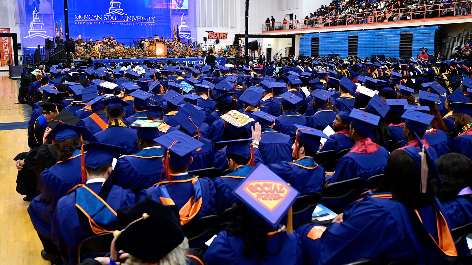 graduates walking across platform to the stage