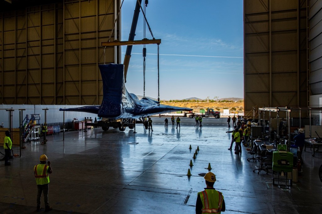 The X-59 Aircraft entering a hangar.