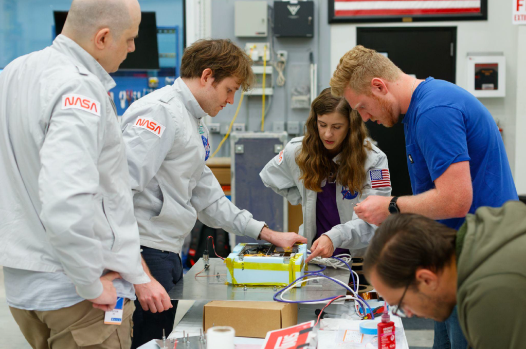 Researchers preparing payload for flight.