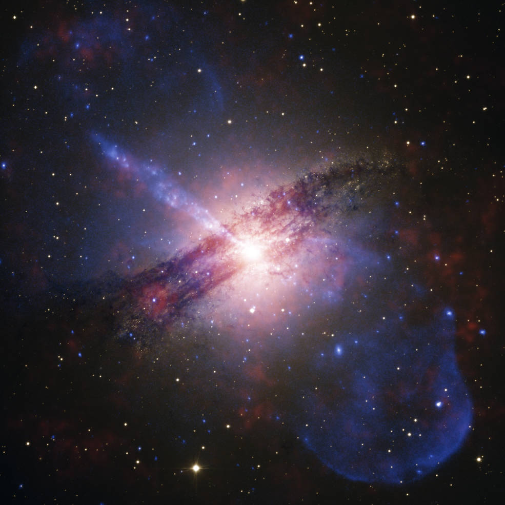 The galaxy Centaurus A (Cen A) shines bright in this image combining data from multiple observatories. In the center of this galaxy is a supermassive black hole feeding off the gas and dust encircling it, and large jets of high-energy particles and other material spewing out