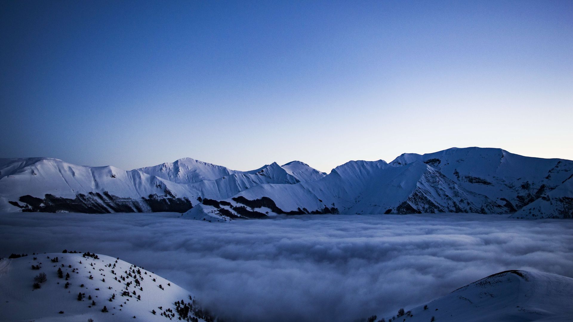 mountain peak foggy blue sky