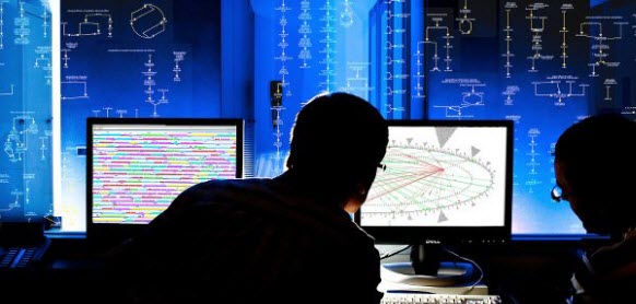 Two men looking at two screens, one
			   showing a genome browser display, the other a
			   regulatory overview display. Behind the
			   screens is a blue background with a portion
			   of a cellular overview diagram visible.