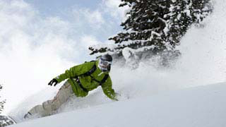 A man downhill skiing