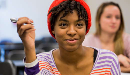 A student smiles in a Georgia Tech classroom.