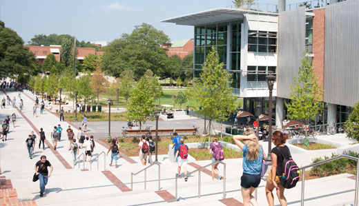 Students walk around central campus, featuring the Clough Undergraduate Learning Commons, Tech Green, and the John Lewis Student Center.