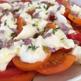 Tomato and mozzarella salad with fresh thyme.