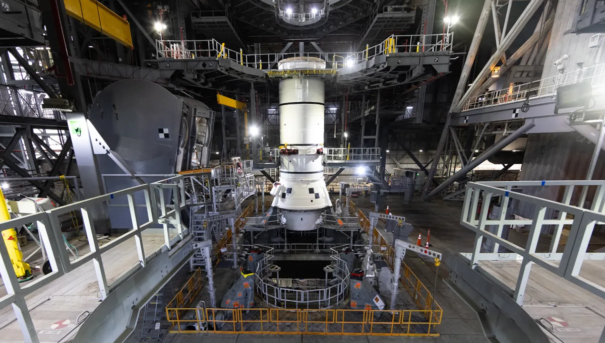 Engineers and technicians stack the left aft assembly for the Artemis II SLS (Space Launch System) solid rocket booster inside the Vehicle Assembly Building at NASA’s Kennedy Space Center in late November. Credit: NASA/Glenn Benson