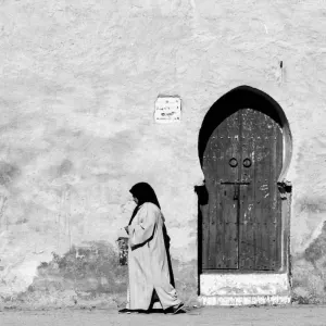 Woman and horseshoe door