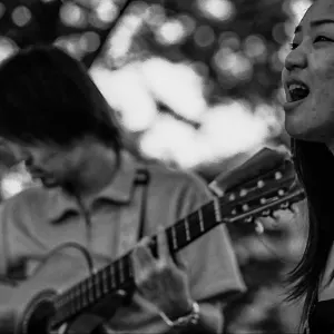 Street musician singing in time to the guitar