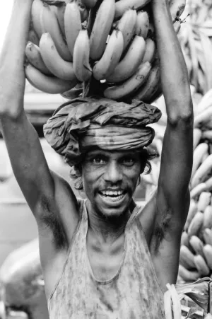 Man carrying bunch of banana