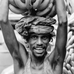 Man carrying bunch of banana