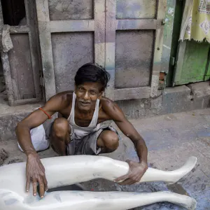 Man touching mannequin